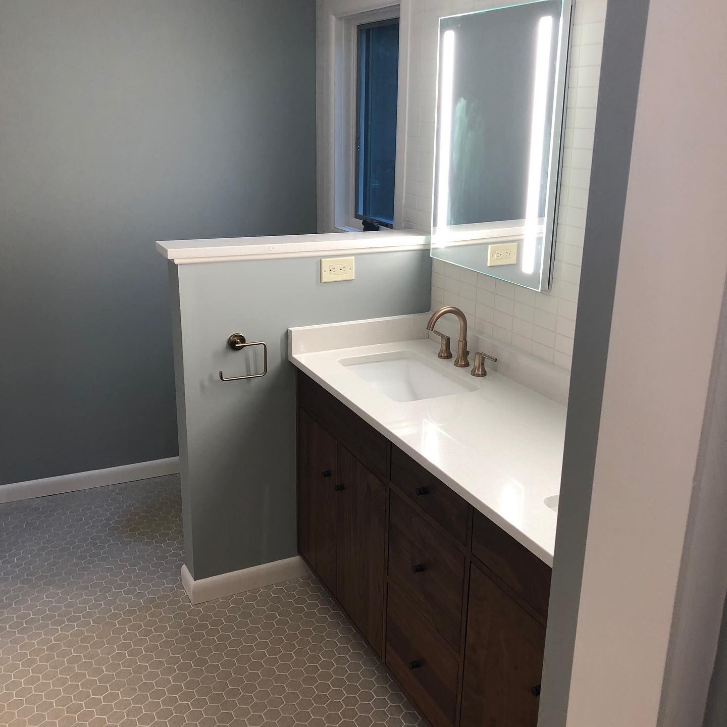 A bathroom with a sink and a mirror on the wall.
