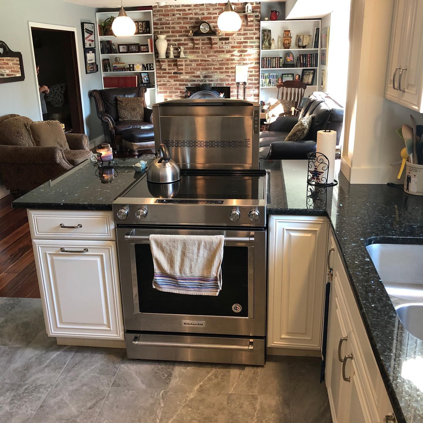 A kitchen with a stove top oven and a sink