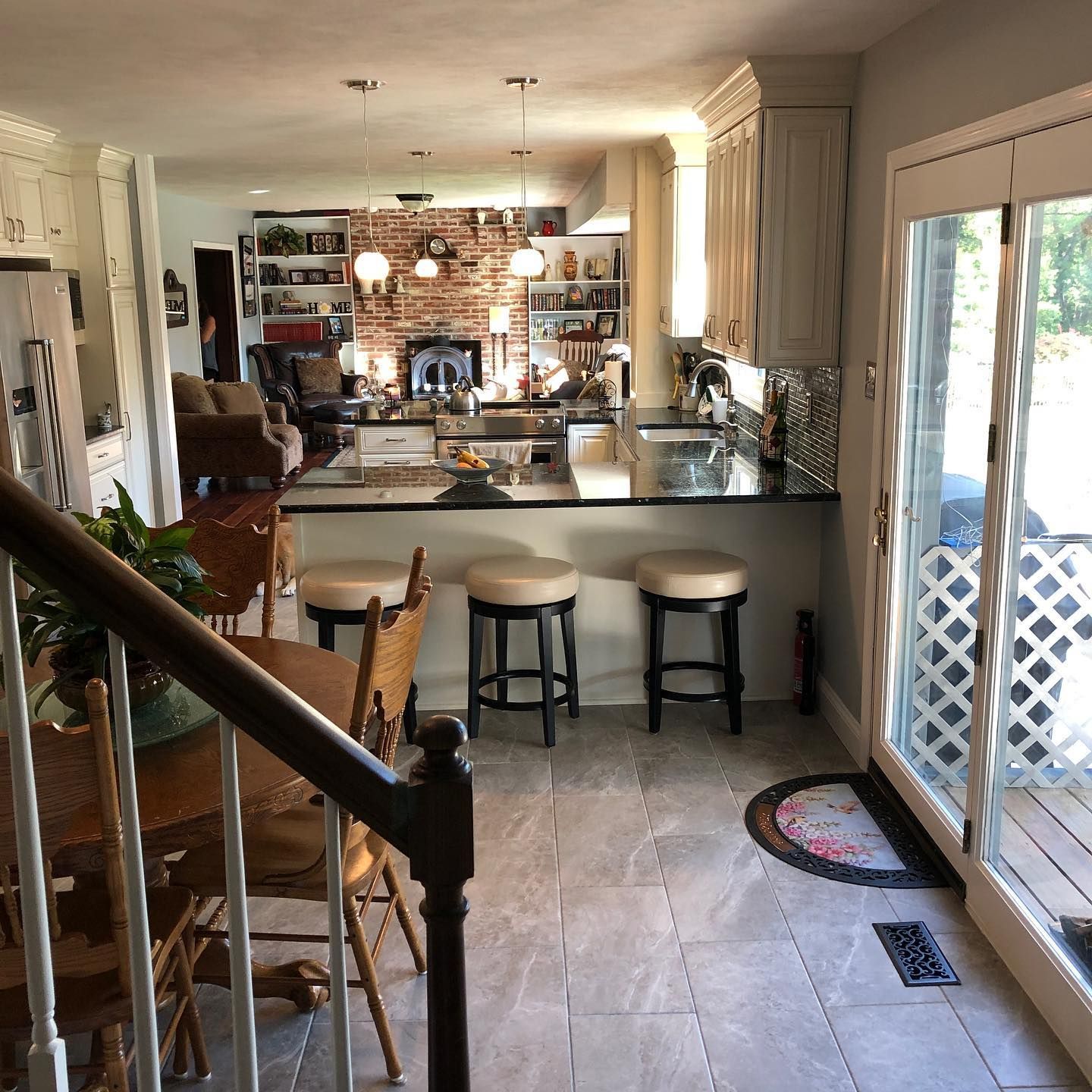 A kitchen with a staircase leading up to it