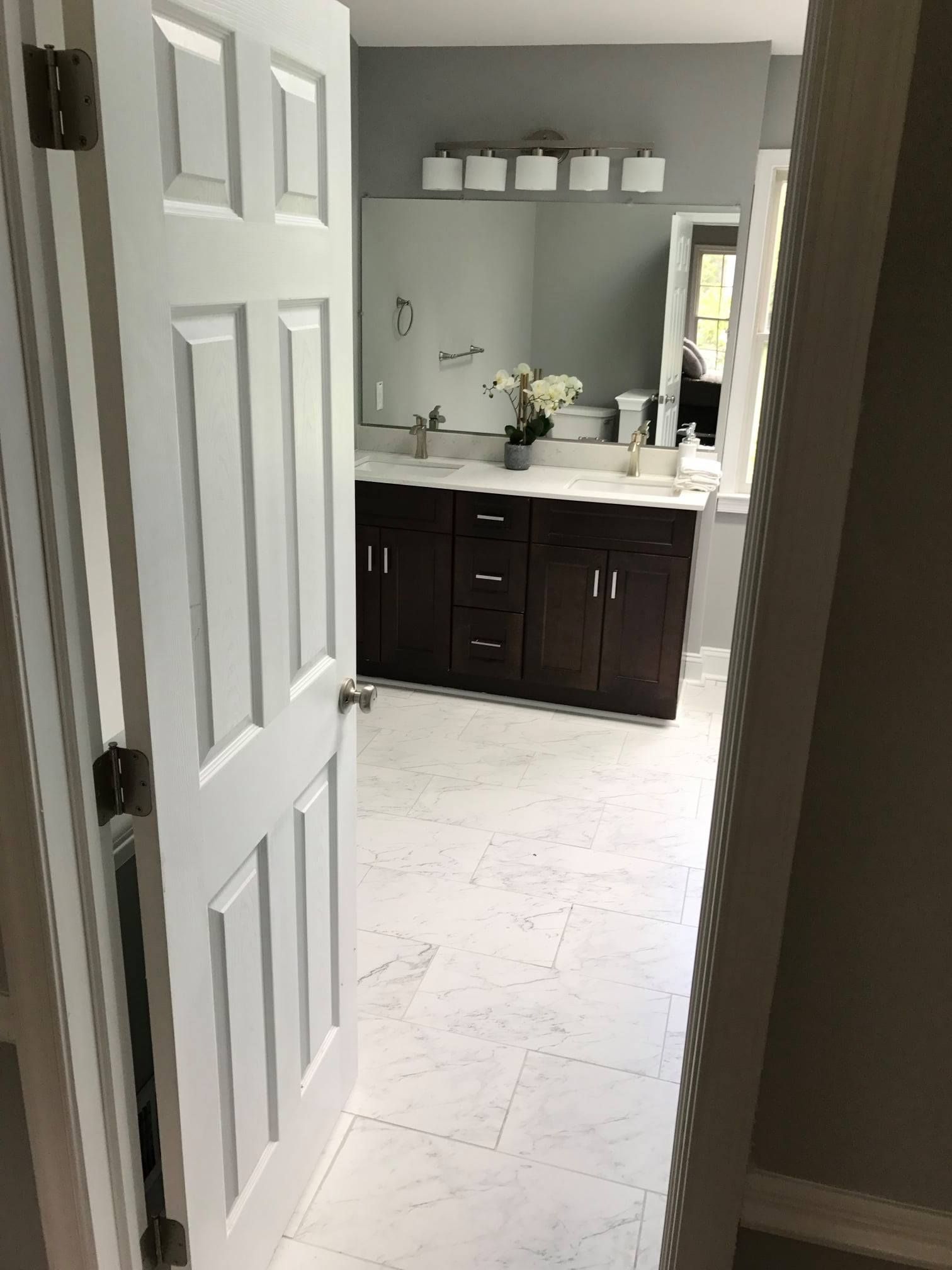 A bathroom with two sinks and a mirror.