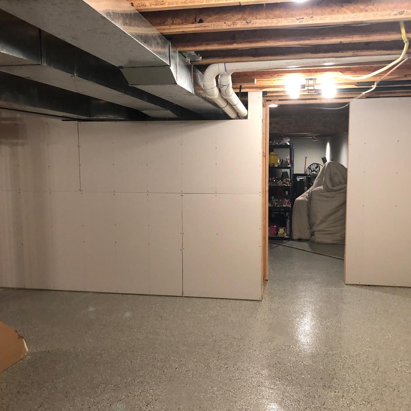 A basement with white walls and a concrete floor