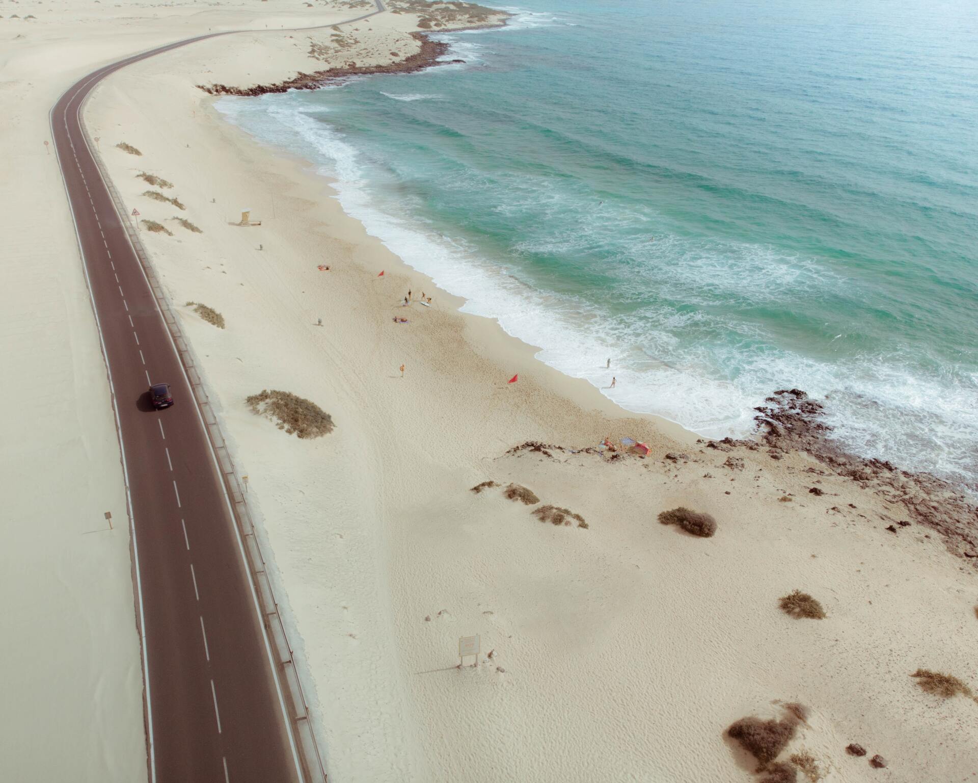 Road passing a beach and the sea