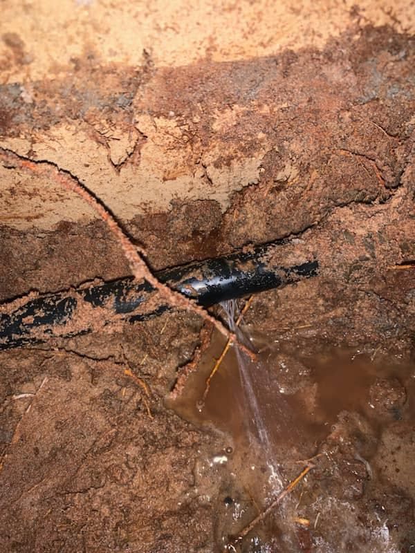 A Pipe Is Leaking Water In A Hole In The Ground — NSL Plumbing and Gas in Banora Point, NSW