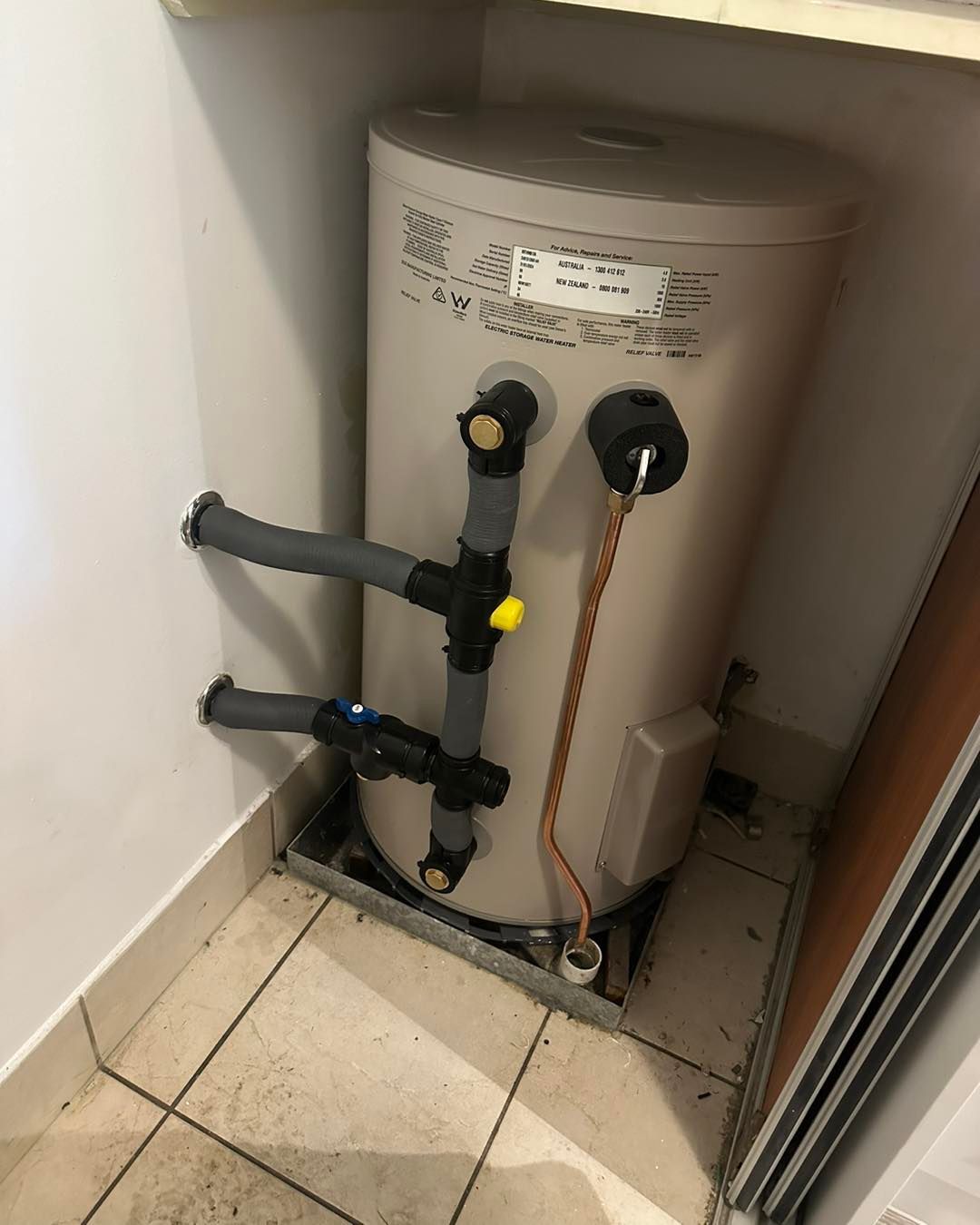 A Water Heater Is Sitting In A Corner Of A Room — NSL Plumbing and Gas in Banora Point, NSW