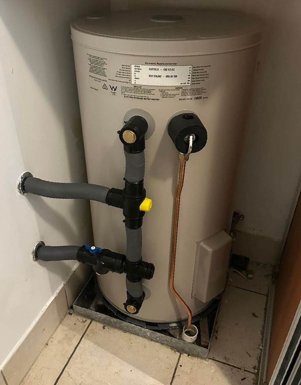 A Water Heater Is Sitting In A Corner Of A Room Next To A Wall — NSL Plumbing and Gas in Banora Point, NSW