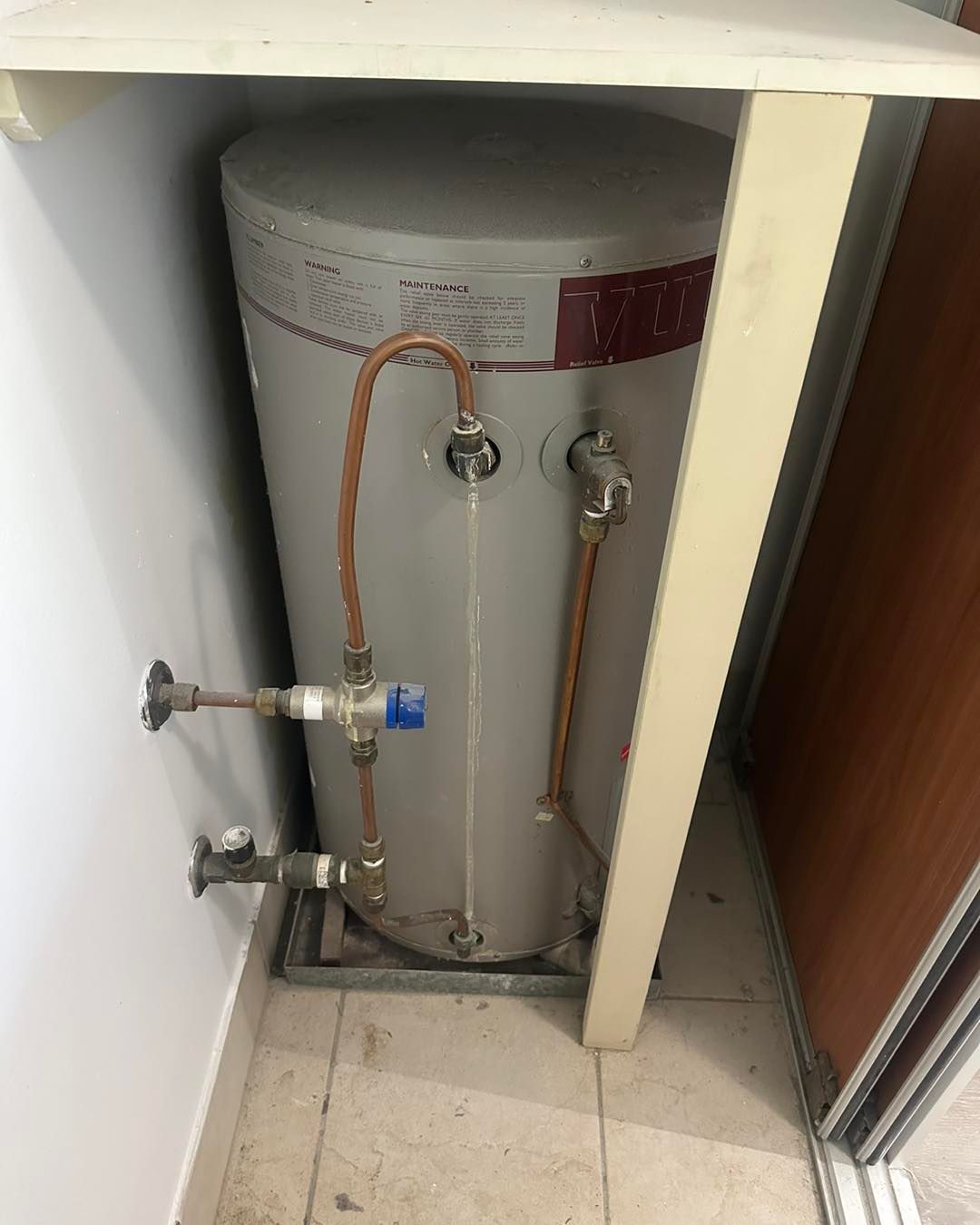 A Water Heater Is Sitting In A Corner Of A Room — NSL Plumbing and Gas in Banora Point, NSW