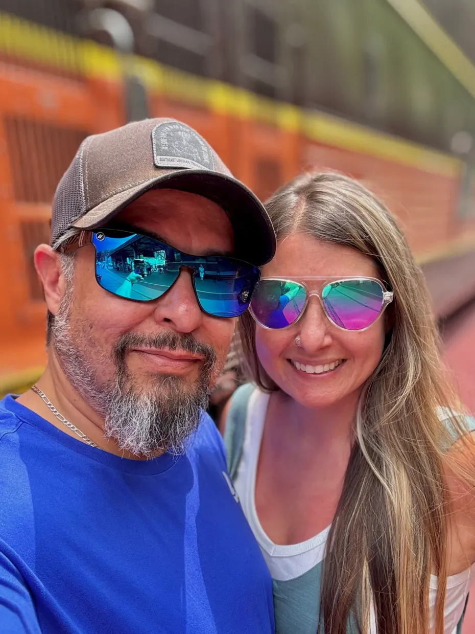 A man and a woman are standing in front of a building.