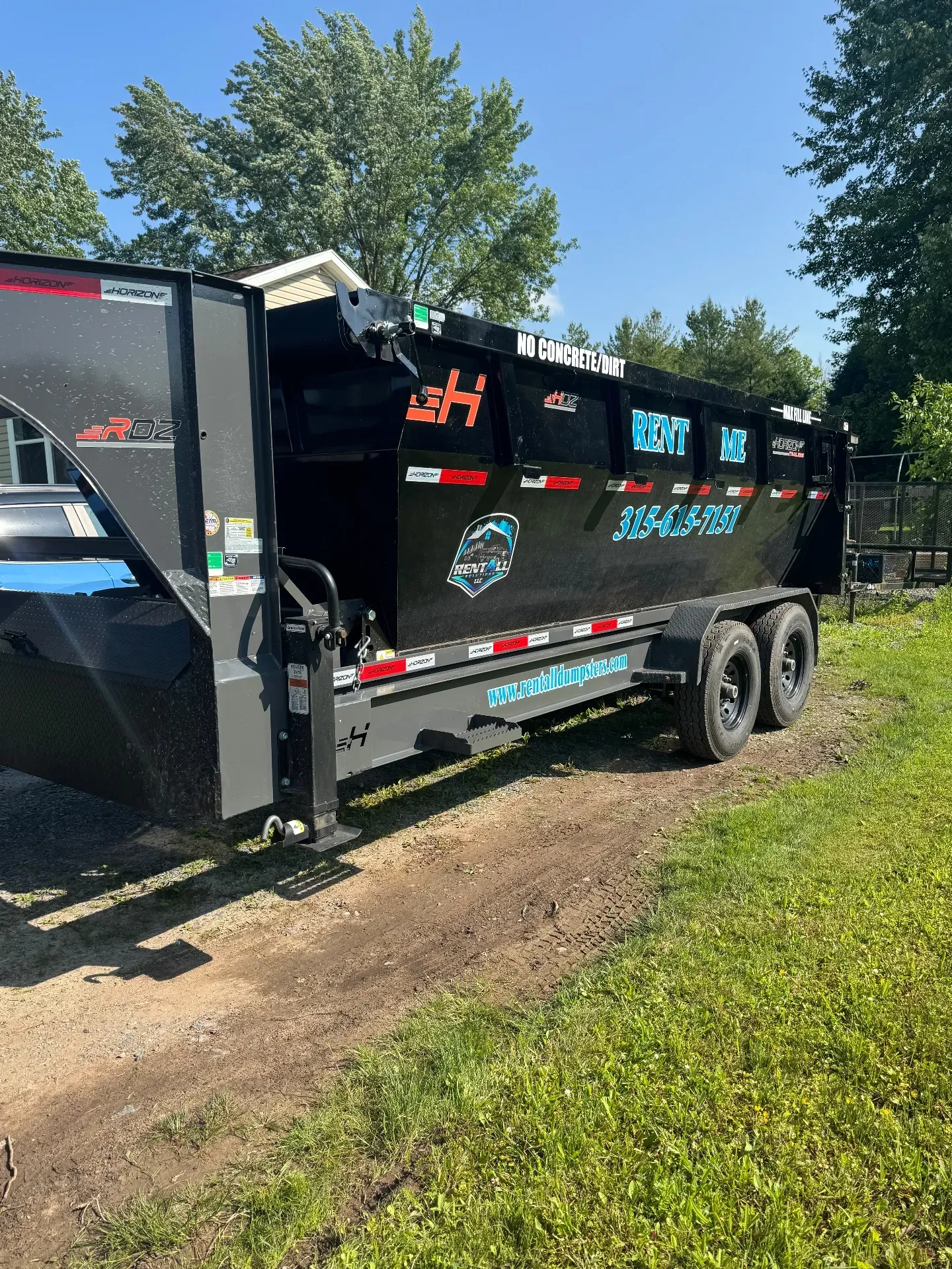 RentAll roll-off trailer carrying a 16-yard dumpster