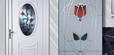 A white door with a stained glass window and a red flower on it.