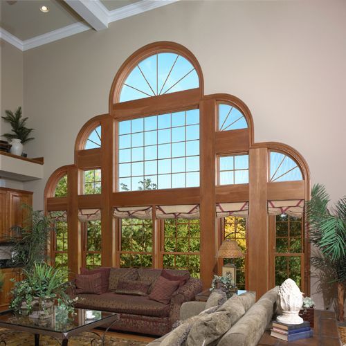 A living room with a couch and lots of windows