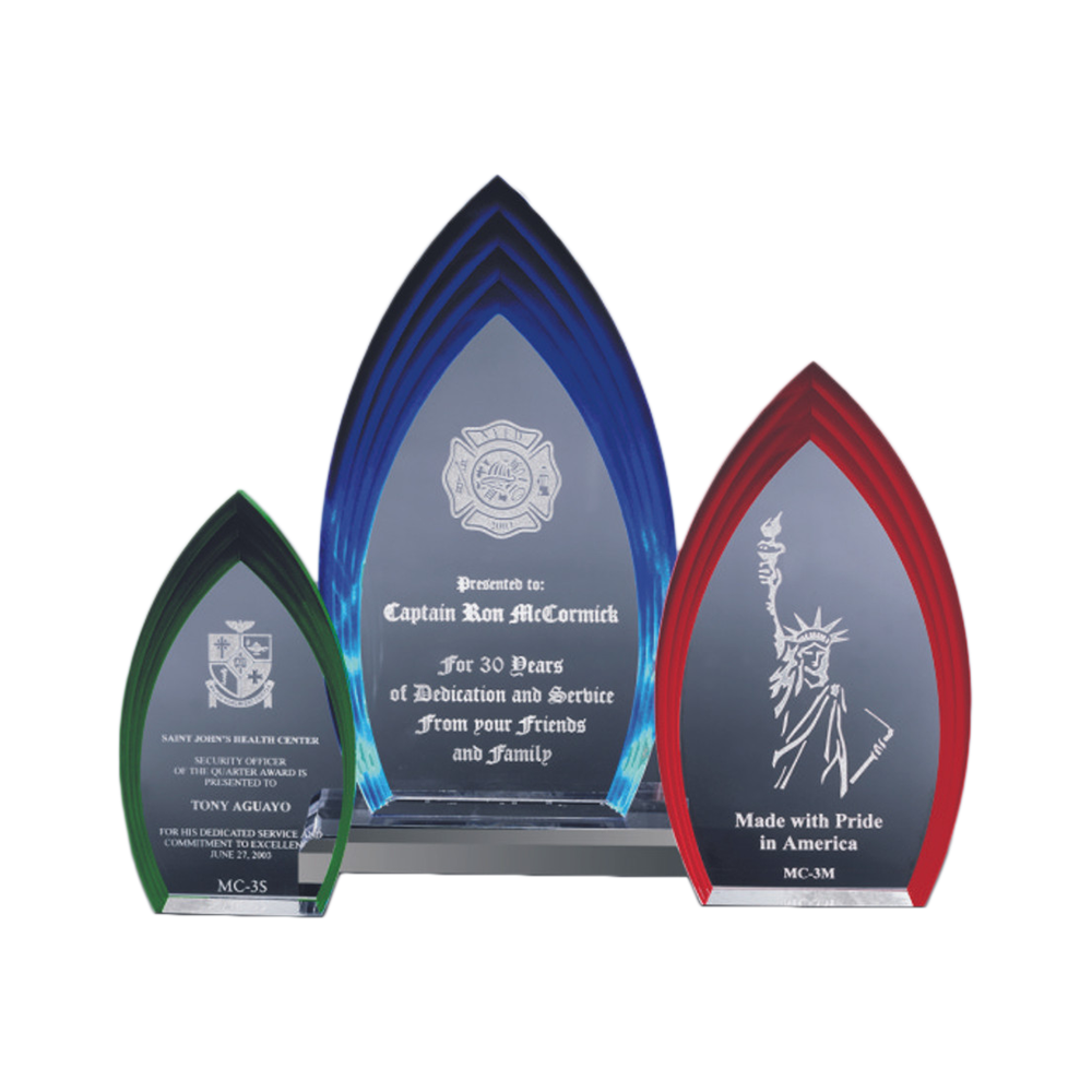 Three blue, red, and green glass award trophies with engraved text on a white background