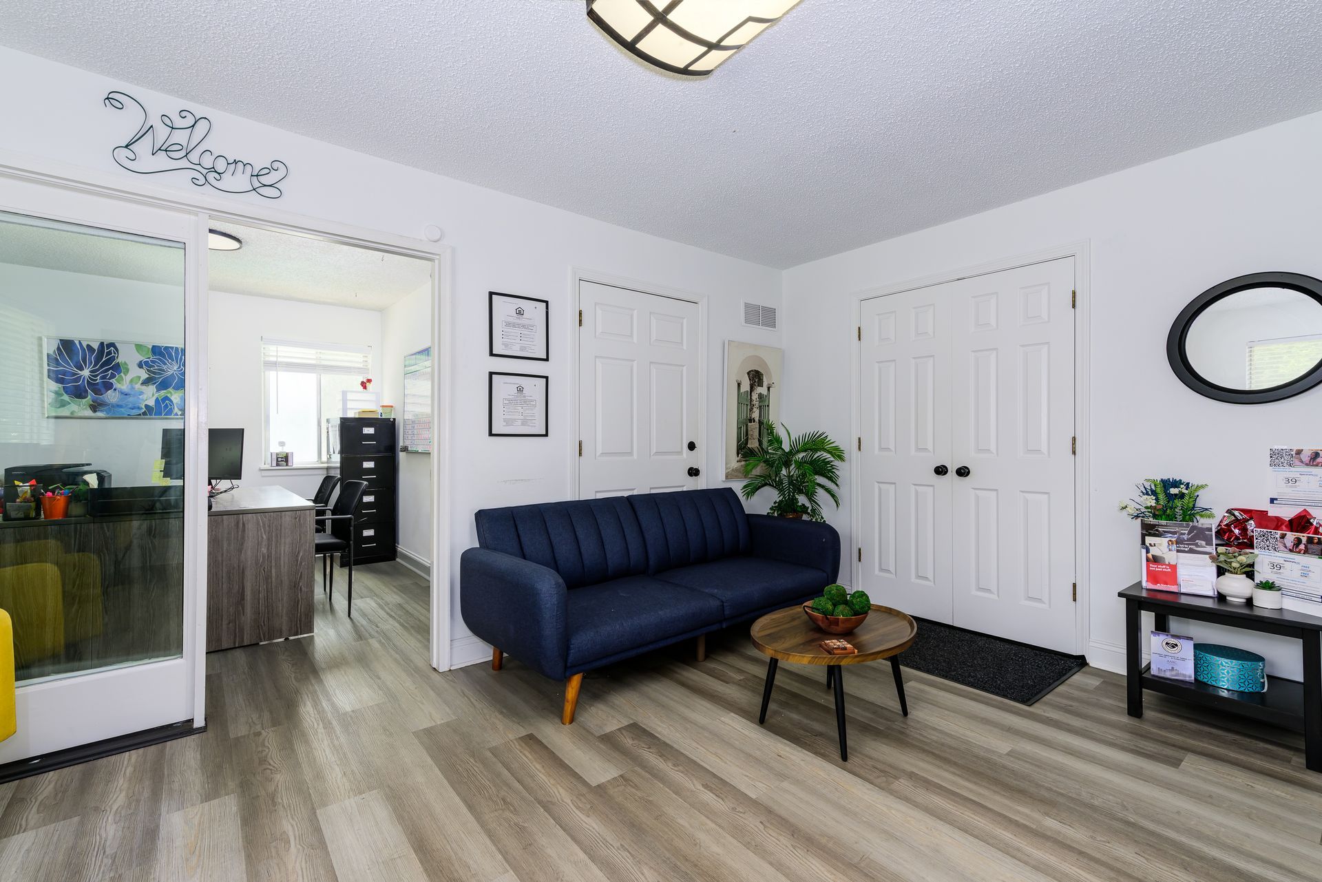 A living room with a blue couch and a coffee table.