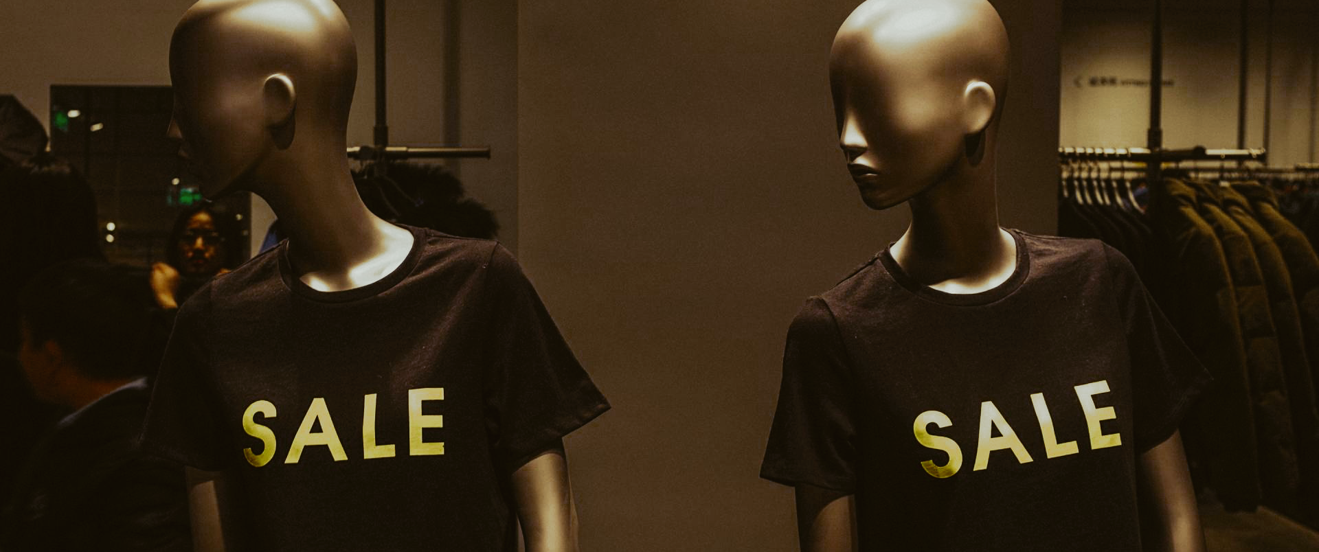 Image of two mannequins with shirts that say “sale”