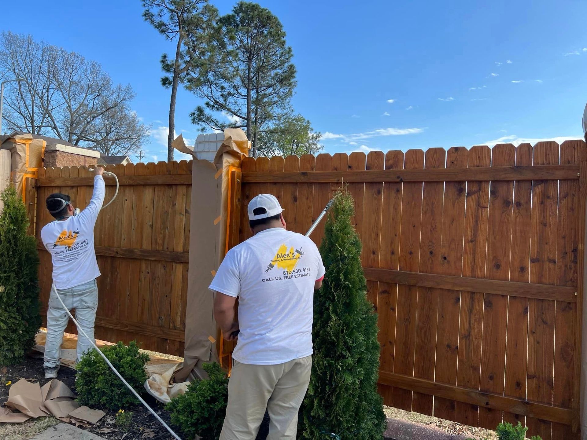 exterior of home fence being stained by alex's painting & remodeling