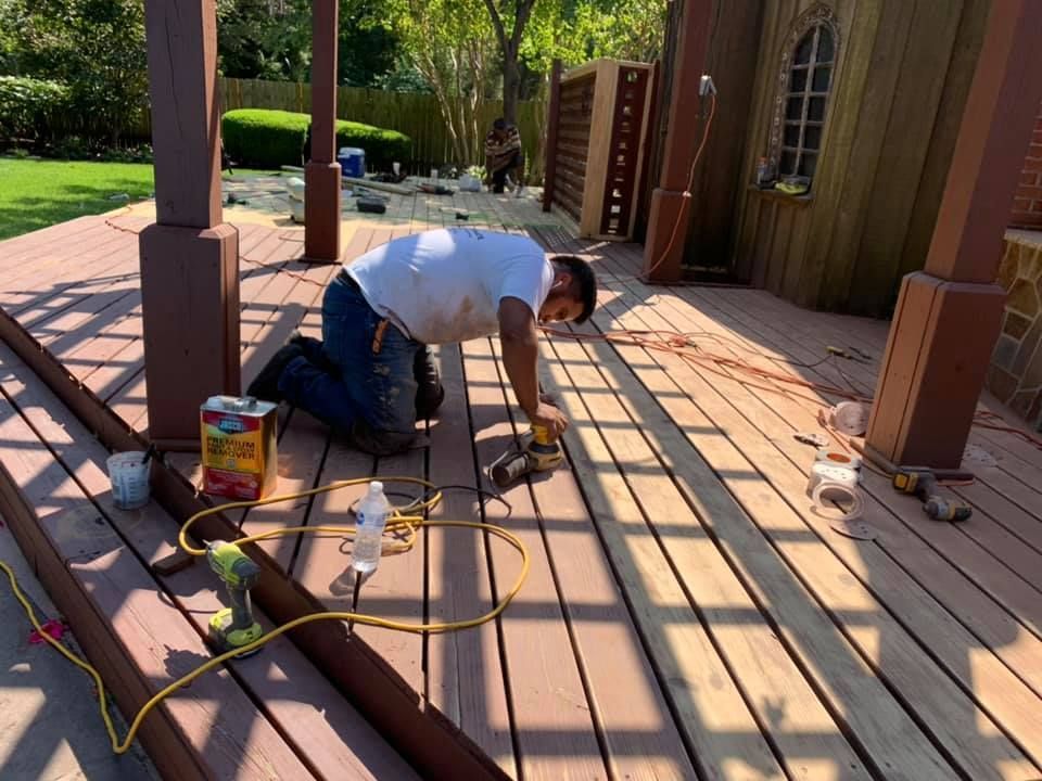 alex's painting & remodeling team staining a deck