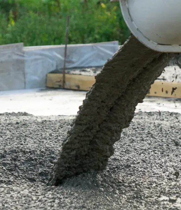 Wet concrete pouring from a mixer into a construction area
