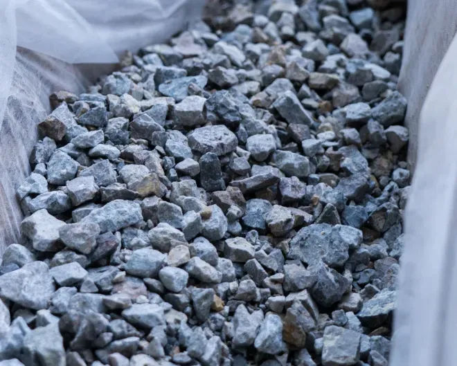 Gray crushed gravel in a white-lined bag or container
