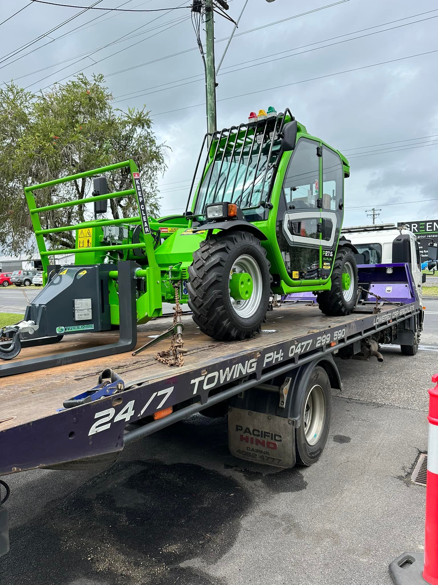 Green Construction Vehicle on a Tow Truck, Parked on a Street — Tigo’s Towing In Cairns City, QLD