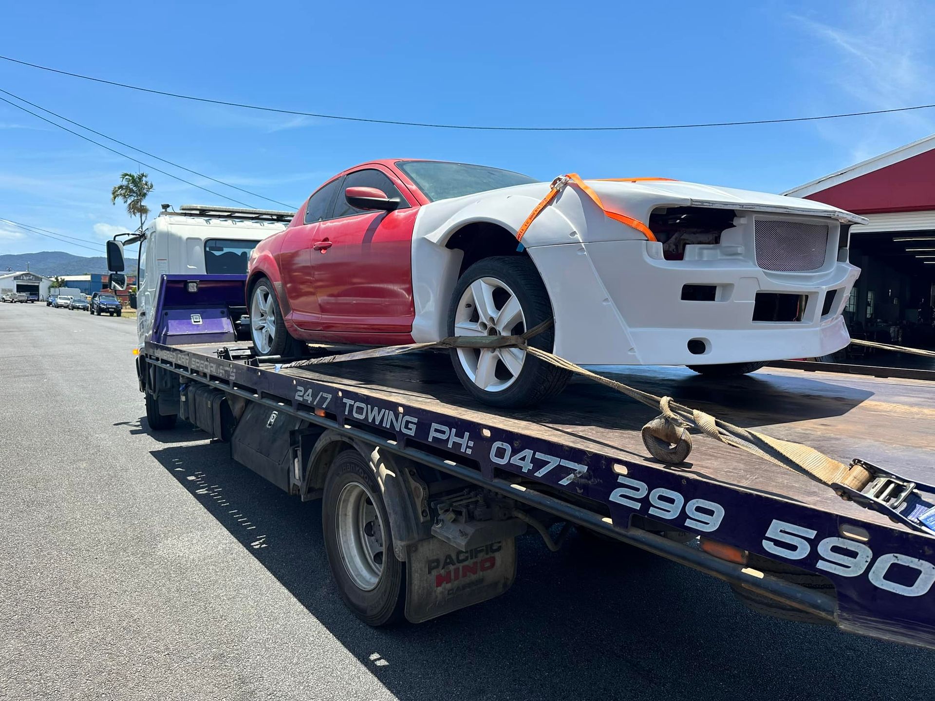 Red and White Car With Damaged Front End on Tow Truck — Tigo’s Towing In Cairns City, QLD