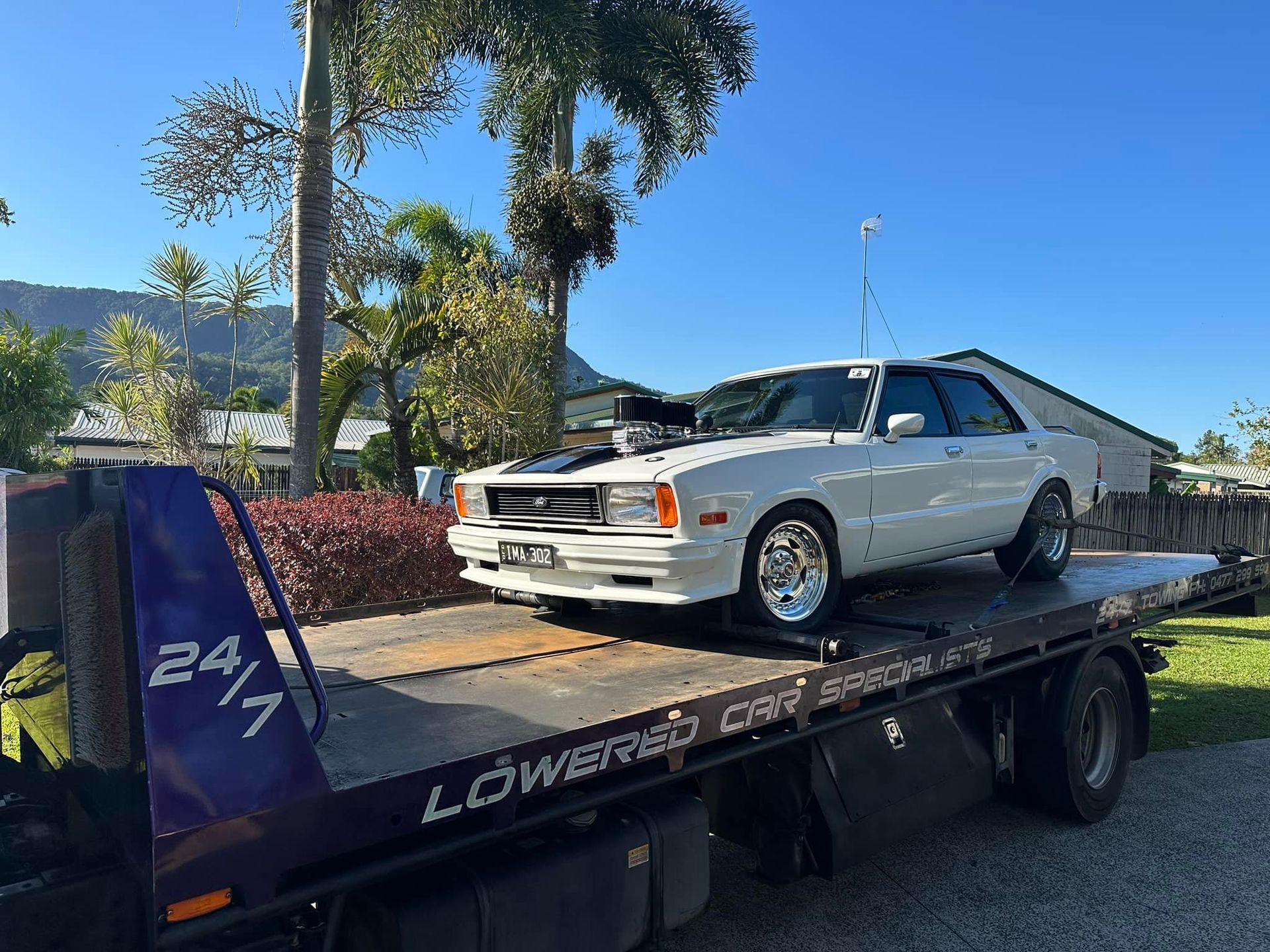 White Car on a Tow Truck, Outdoors — Tigo’s Towing In Cairns City, QLD