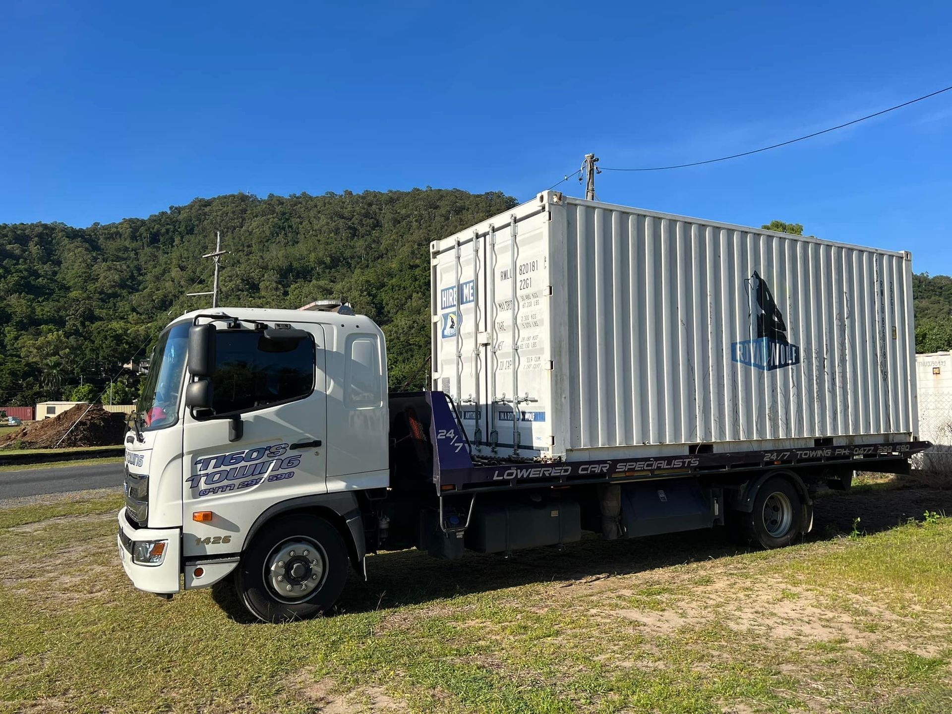 White Truck Carrying a White Shipping Container on a Sunny Day — Tigo’s Towing In Cairns City, QLD