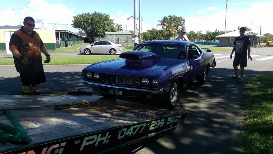 Purple Muscle Car on a Tow Truck, Two Men Standing Near It — Tigo’s Towing In Cairns City, QLD