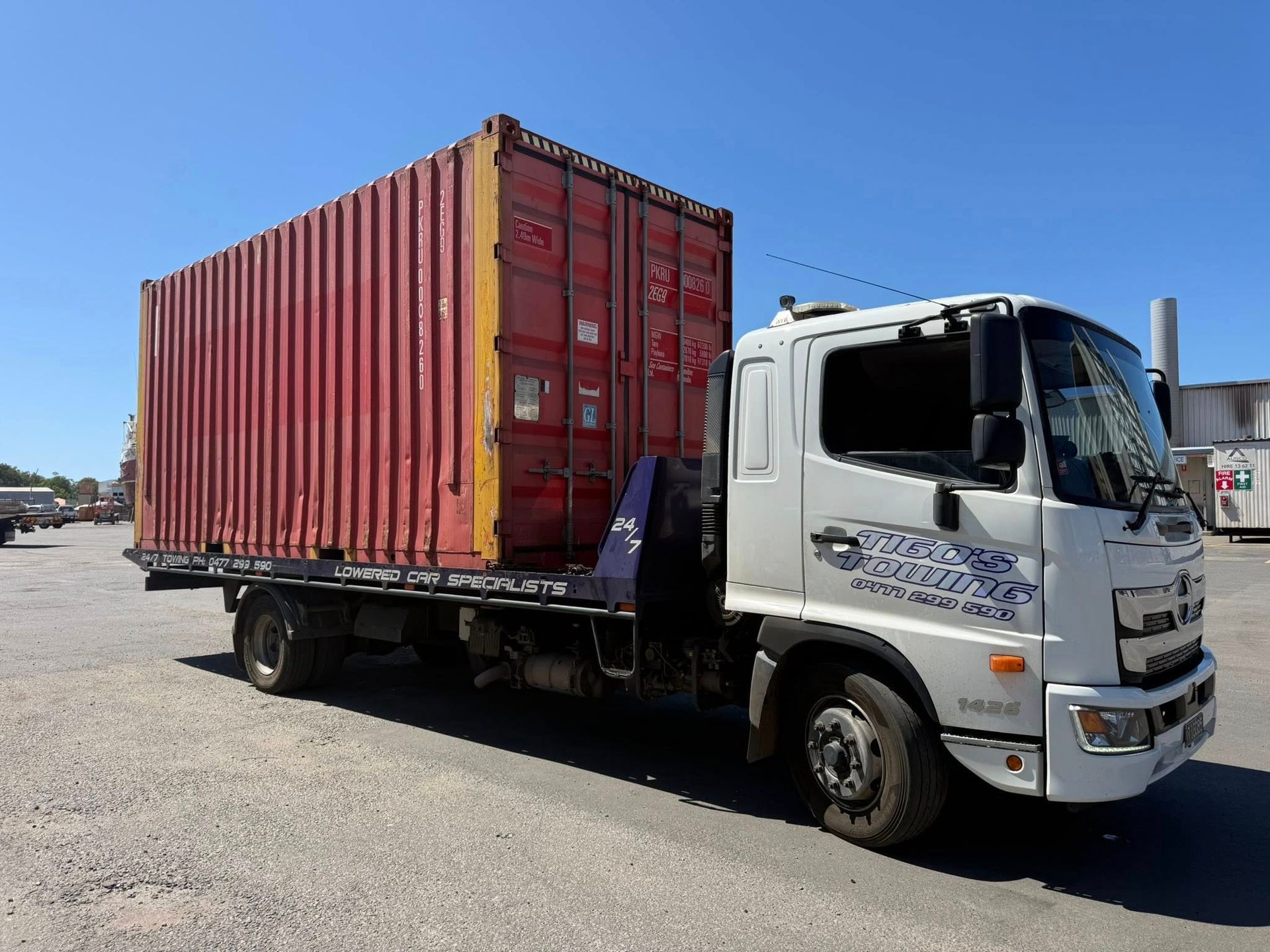 Flatbed Tow Truck Carrying a Small Gray Building — Tigo’s Towing In Cairns City, QLD