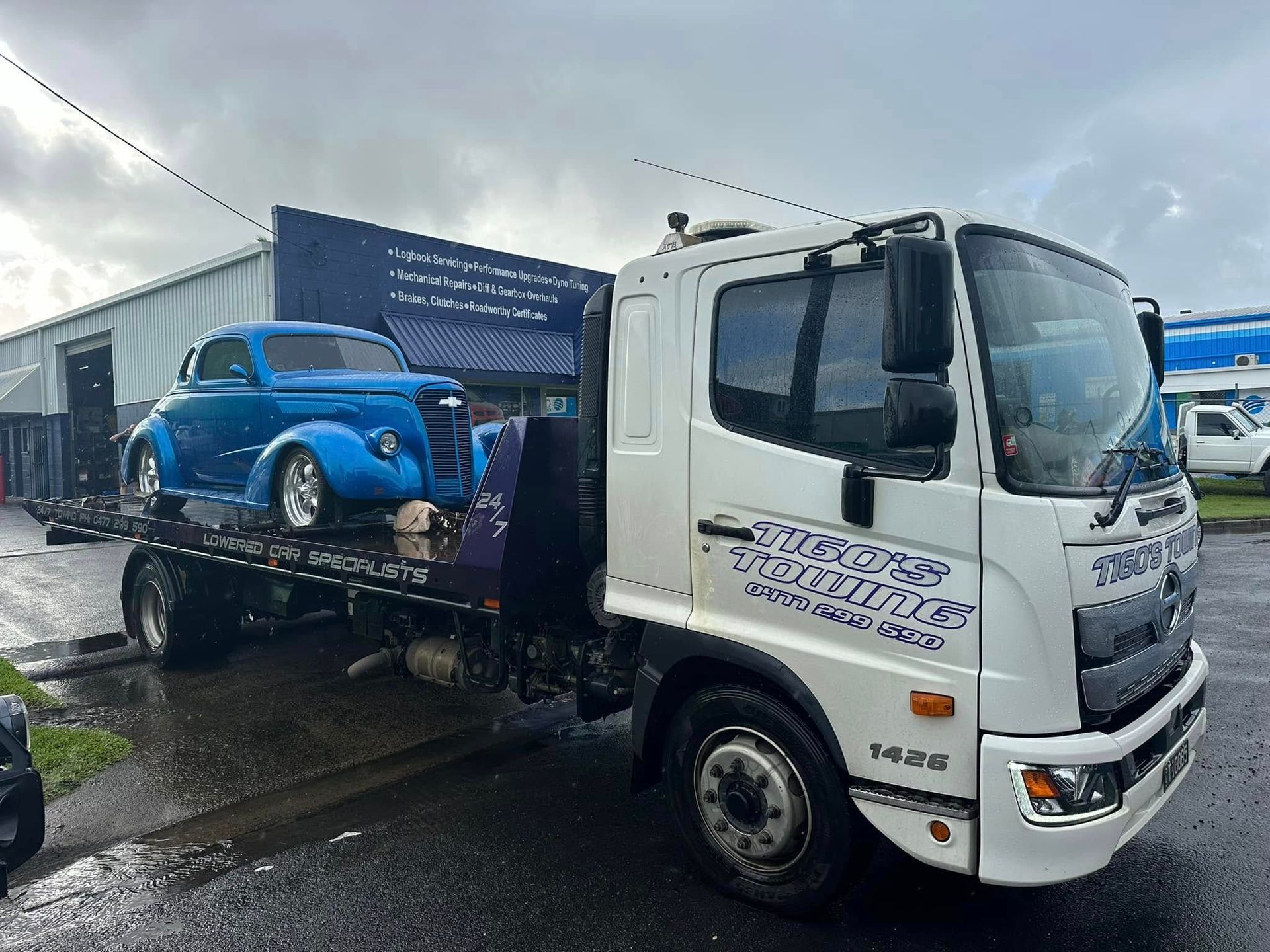 White Tow Truck Carrying a Blue Classic Car — Tigo’s Towing In Cairns City, QLD