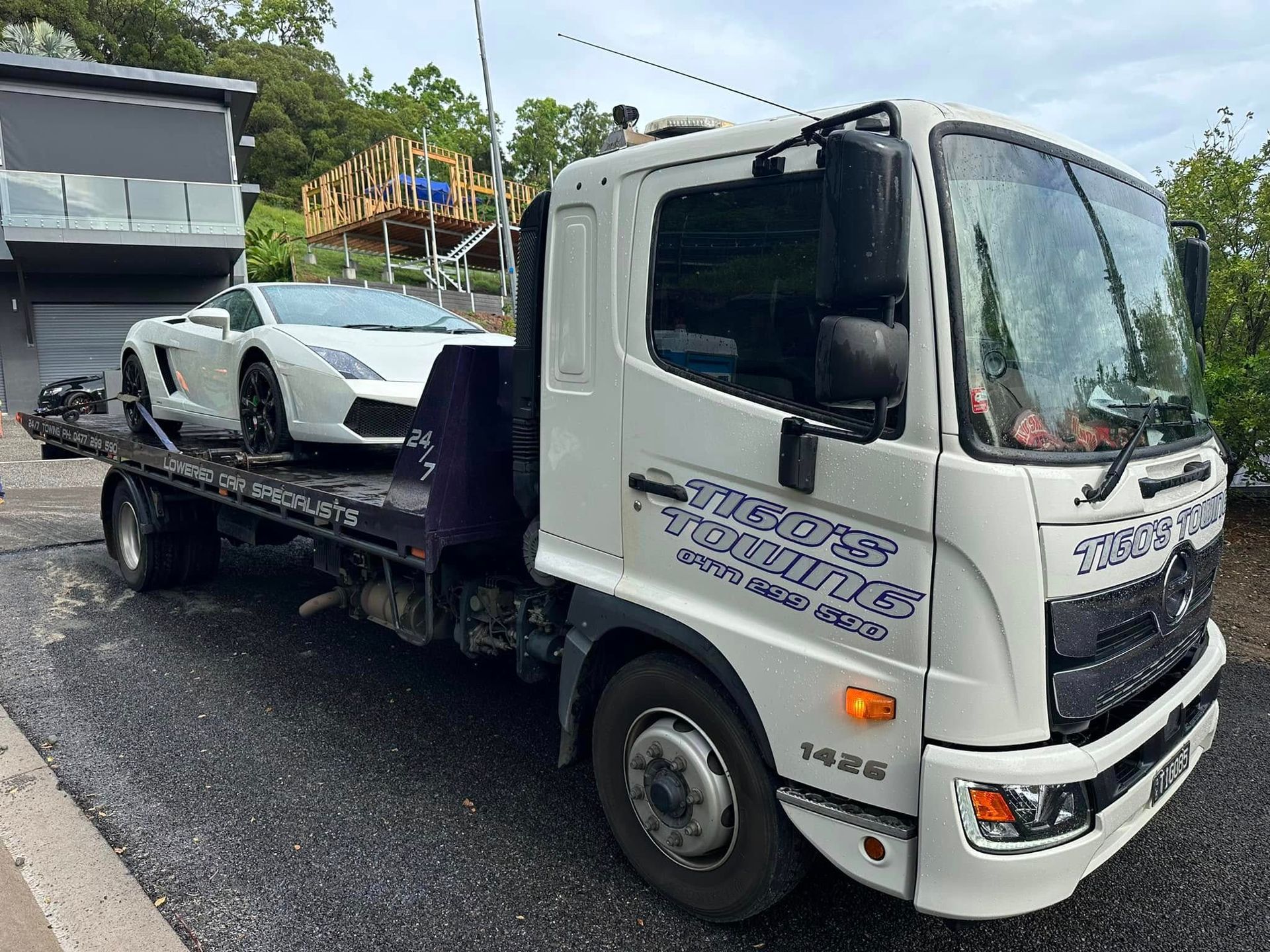 White Lamborghini Loaded on a Flatbed Tow Truck — Tigo’s Towing In Cairns City, QLD