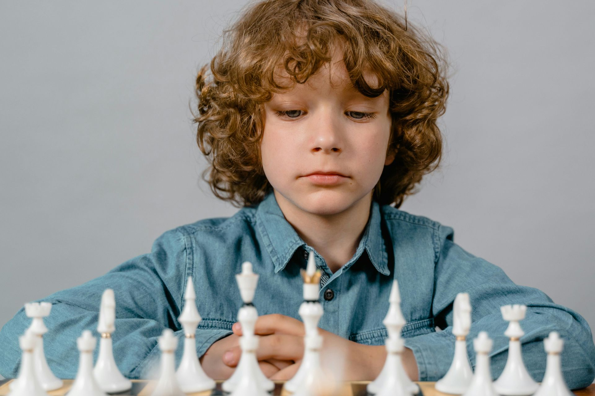 A young boy is playing a game of chess.