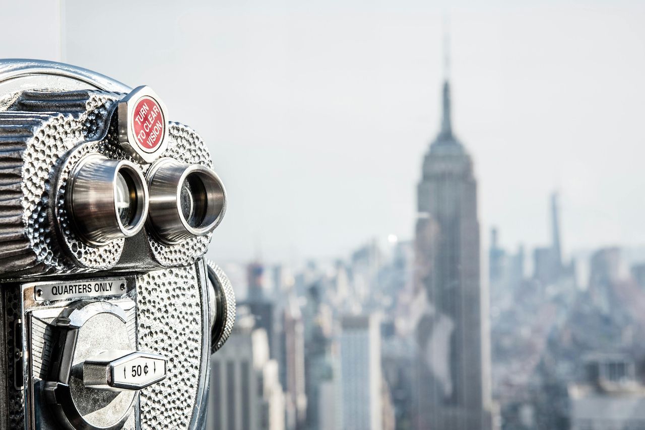 Binoculars overlooking the New York City skyline, focused on the Empire State Building.