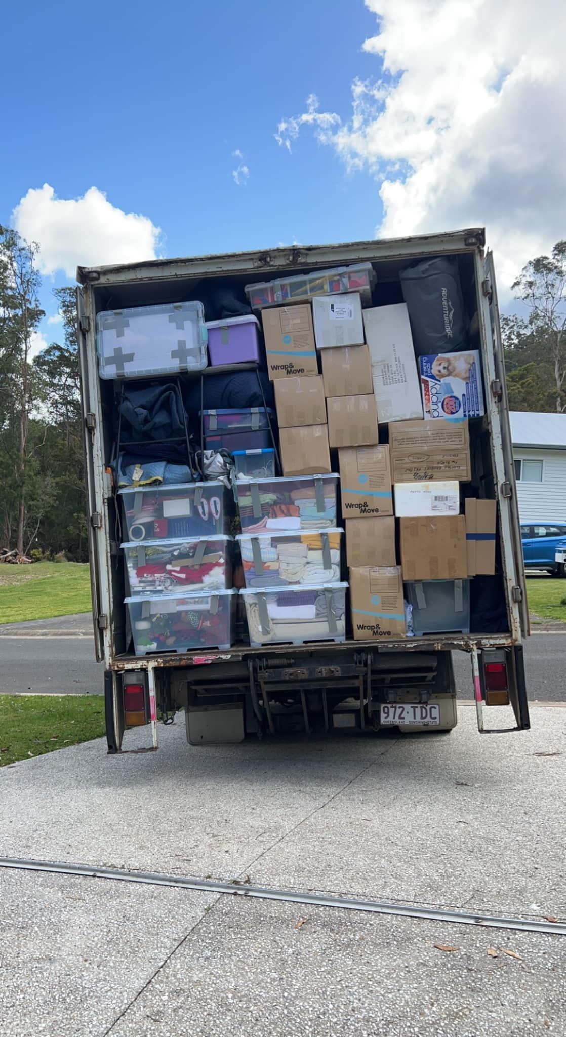 Truck loaded with boxes and containers, likely for a move, parked on driveway. — Gantic Removals Ipswich in Ipswich, QLD