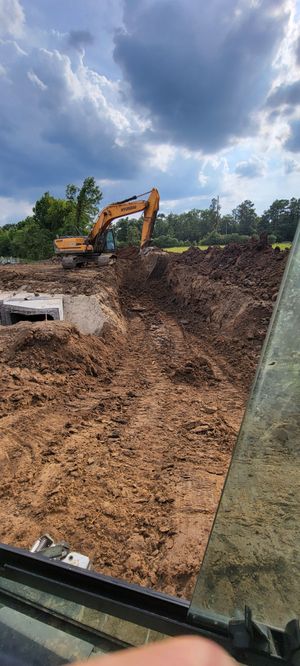 A large excavator is moving dirt on a construction site.