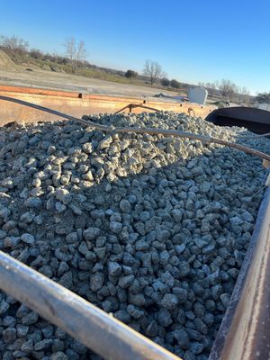 A pile of gravel is sitting on top of a train track.