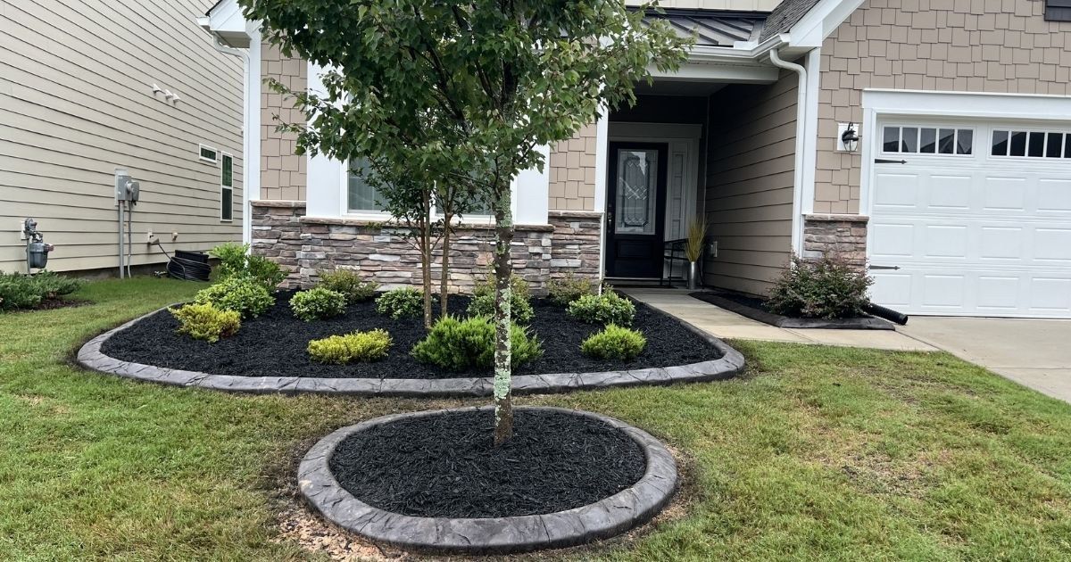 Finished decorative concrete curbing around front yard landscape beds in Tega Cay SC