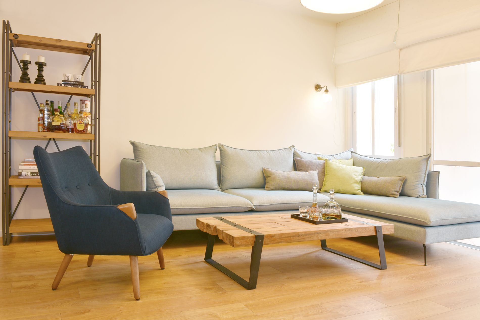 סלון עם ספה, כיסא, שולחן קפה ומדף ספרים.