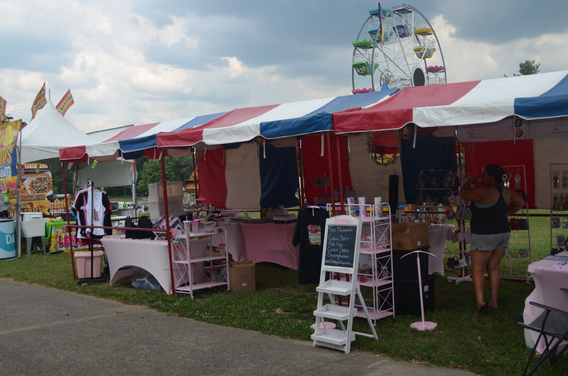 Red food truck with American flags, serving customers outdoors.