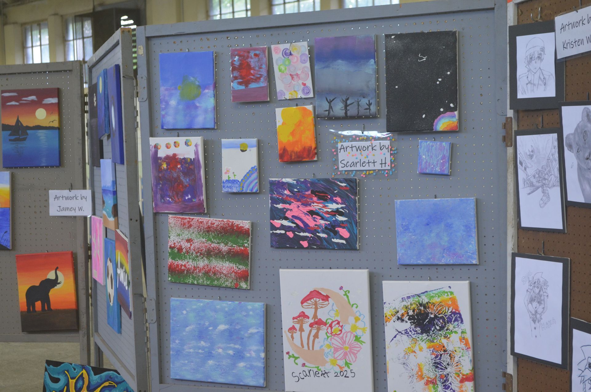 Aerial view of brightly lit carnival at dusk with Ferris wheel, crowds, and food stalls.