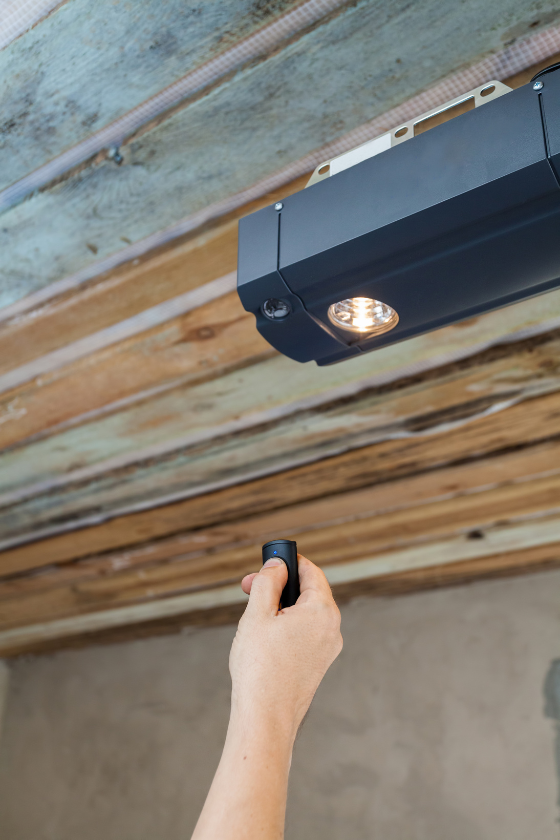 A person is using a remote control to open a garage door.