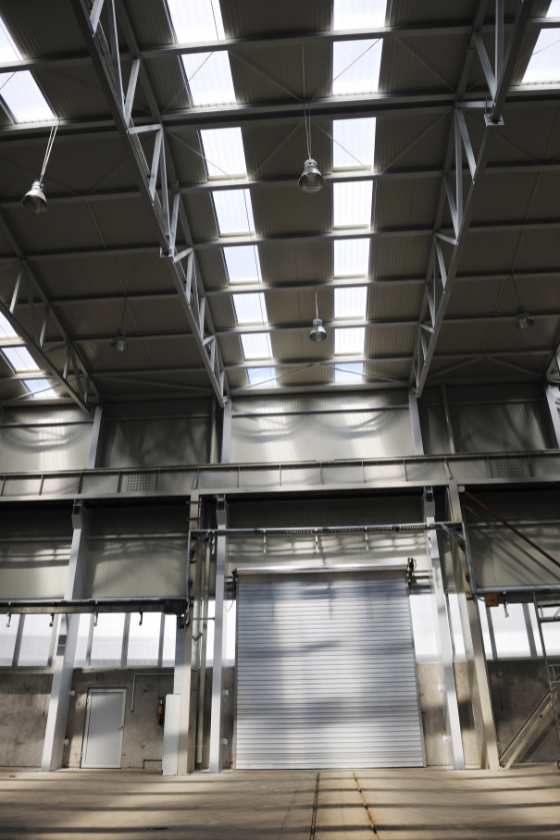 A large warehouse with a ceiling that has a lot of windows