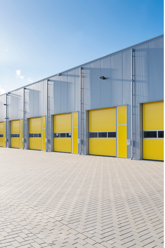 A row of yellow garage doors on a building