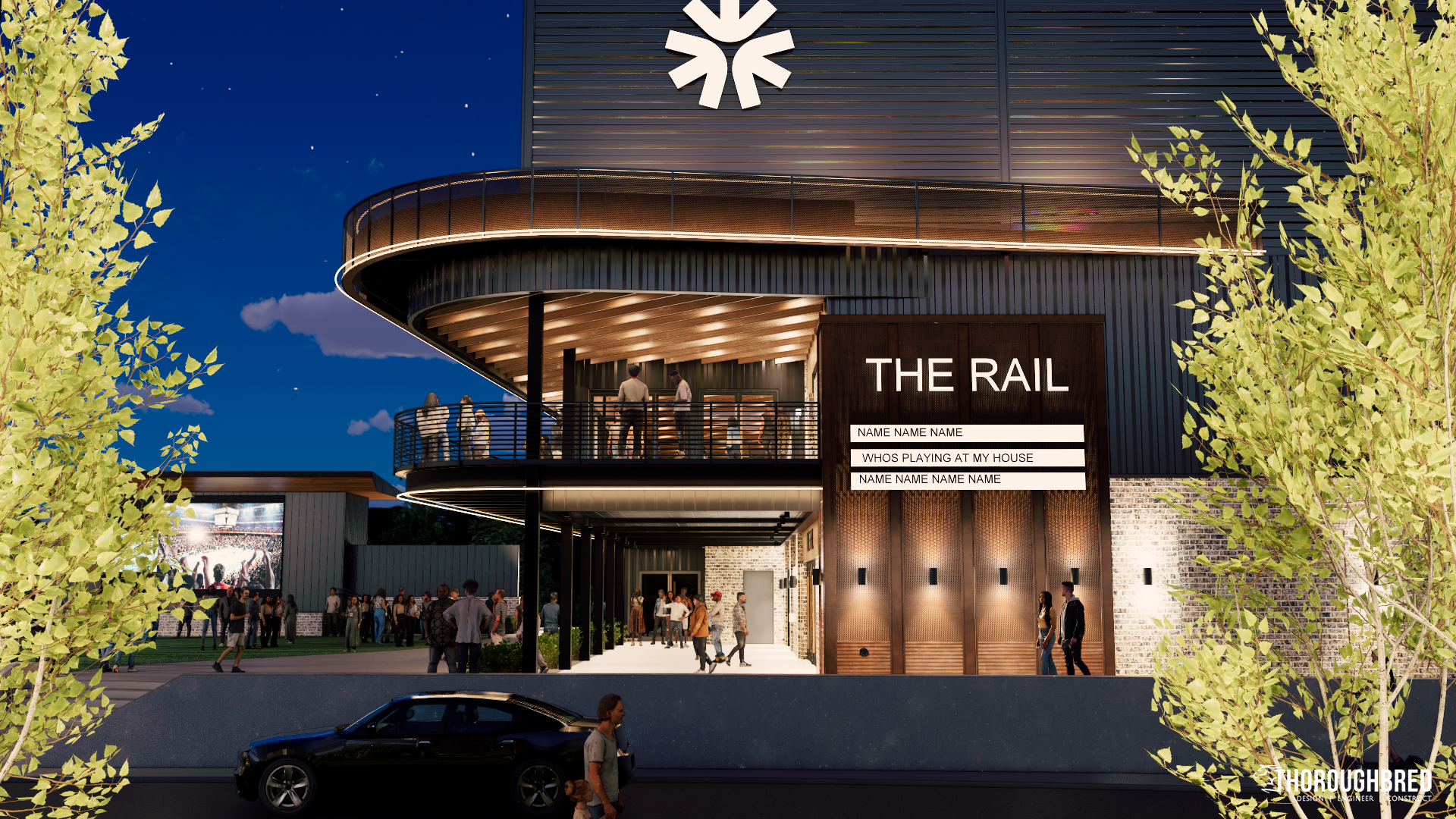 Exterior view of The Rail entertainment venue at dusk with people. Building has sign, lighting, and an upper level balcony.