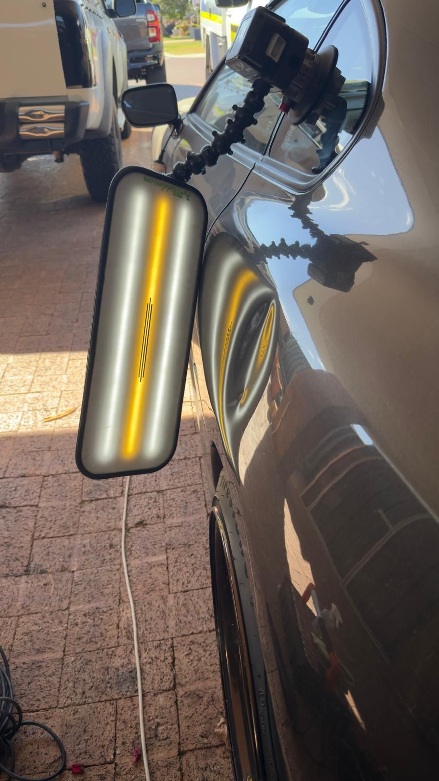 Silver car fender with a dent.