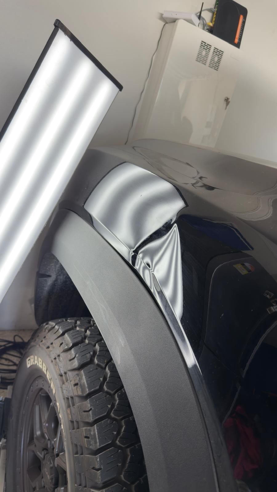 Bright red pickup truck, black accents, parked outdoors.