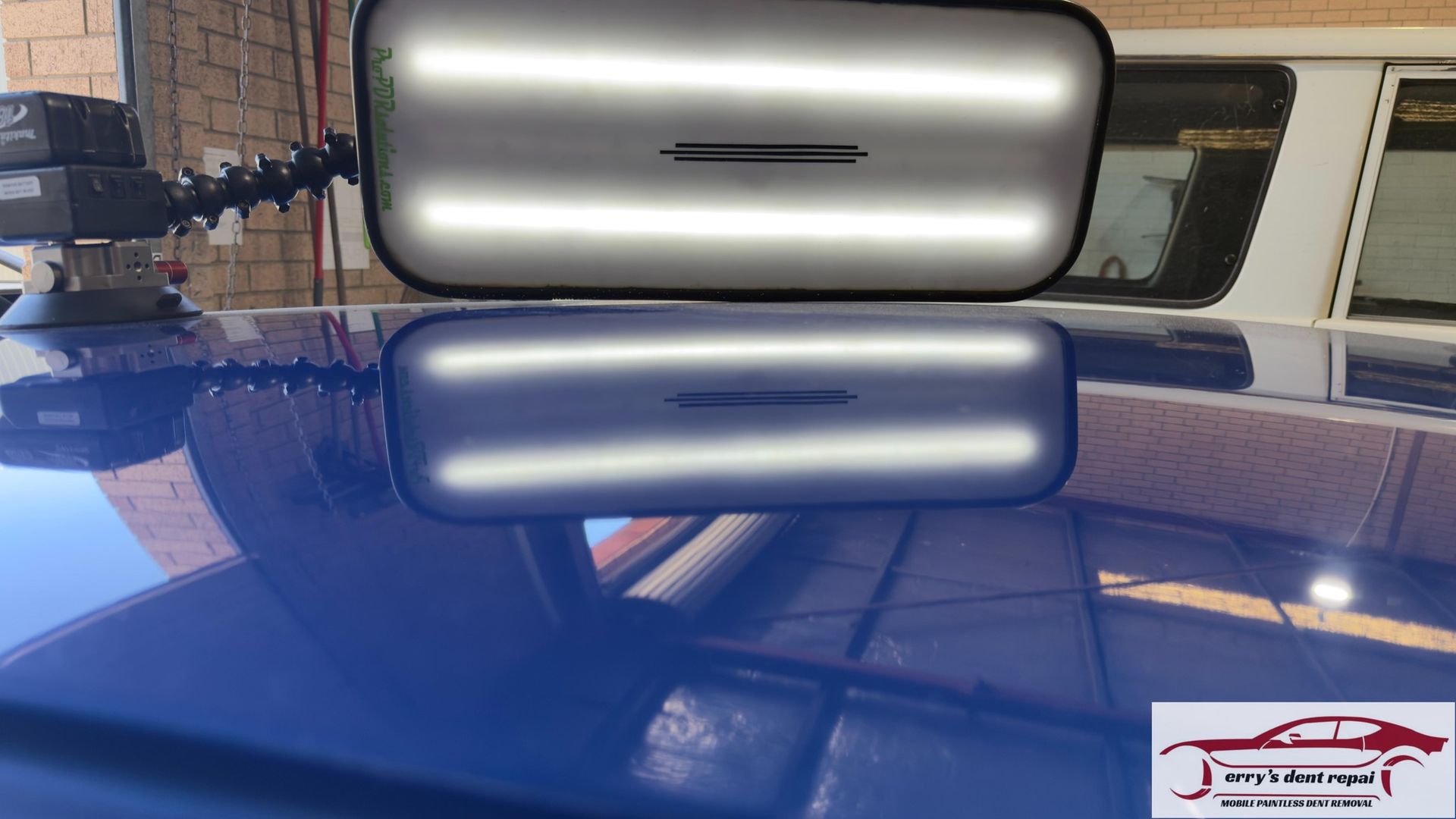 White car rear quarter panel with taillight, parked in driveway.