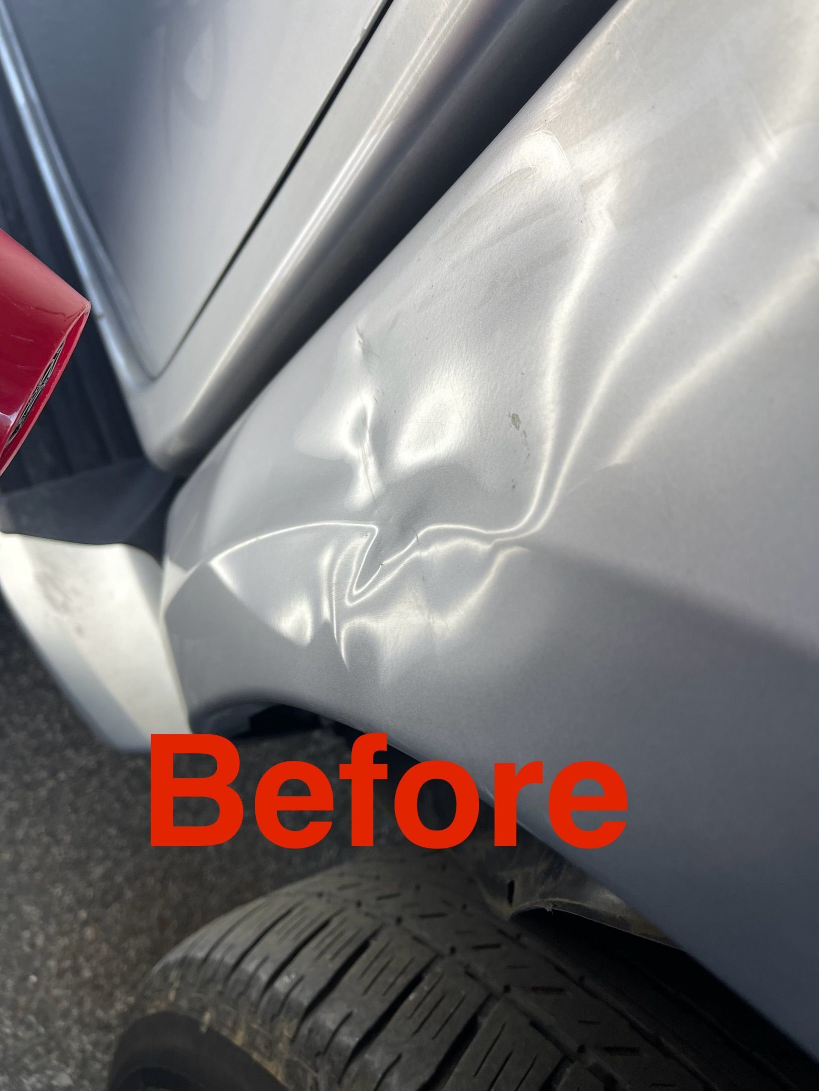 Damaged white car panel with a dent near the tire, labeled 