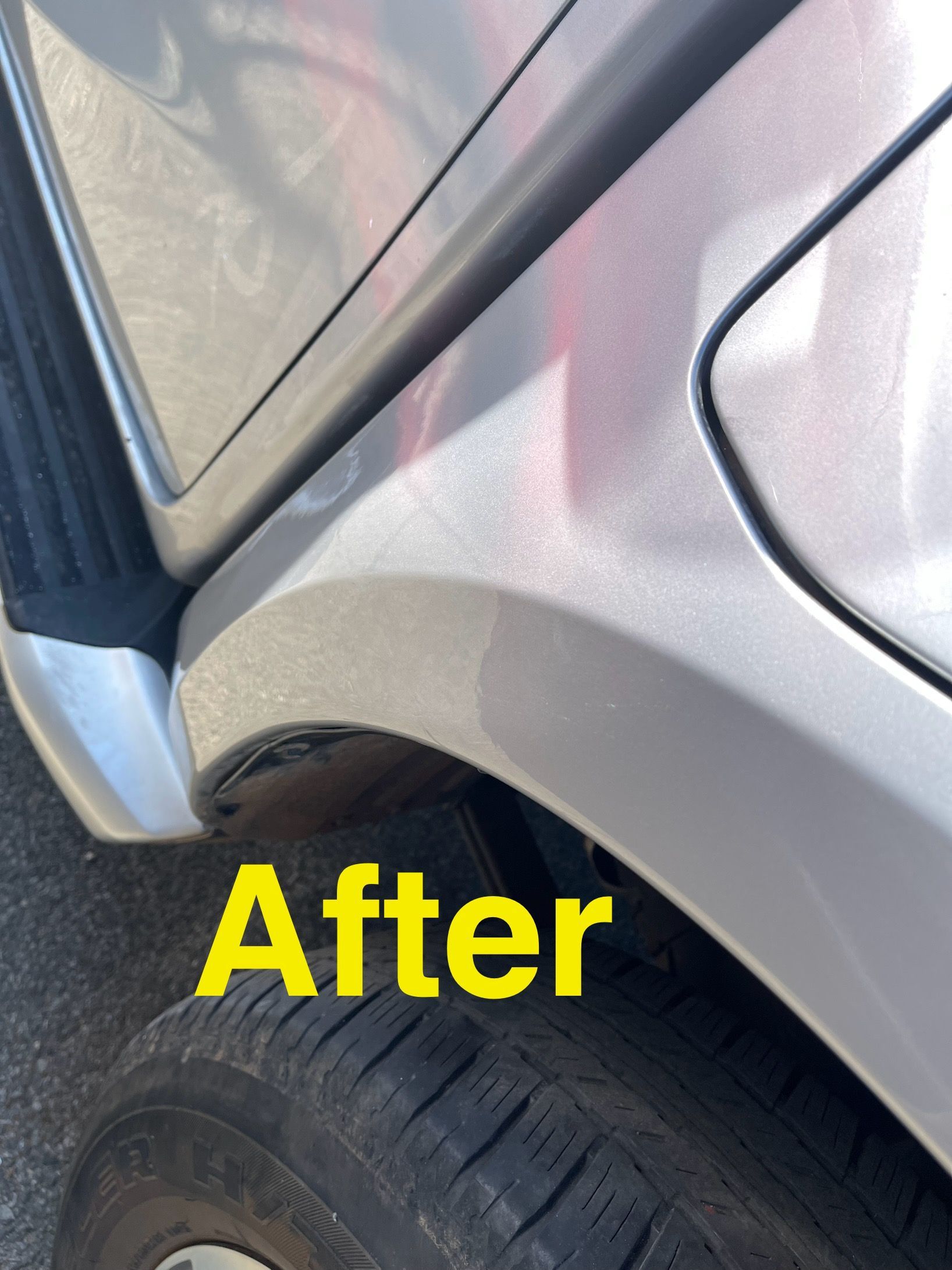 Silver car's wheel well after repair, showing smooth paint and no damage.