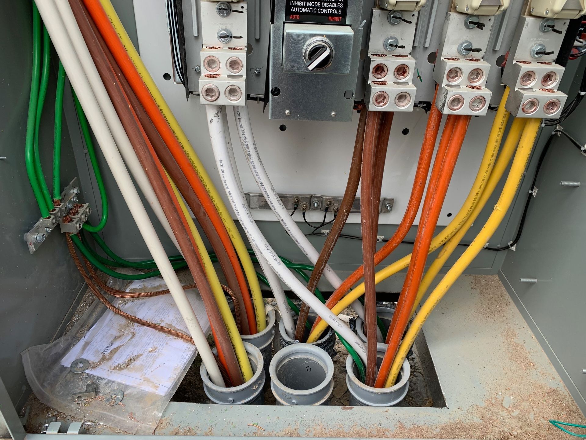 Electrical panel with colored wires connected to breakers.