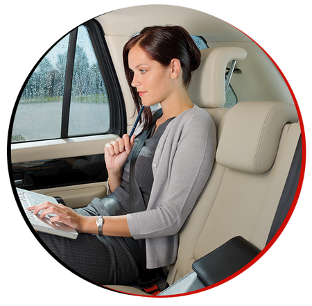 woman sitting in the car and working on the laptop