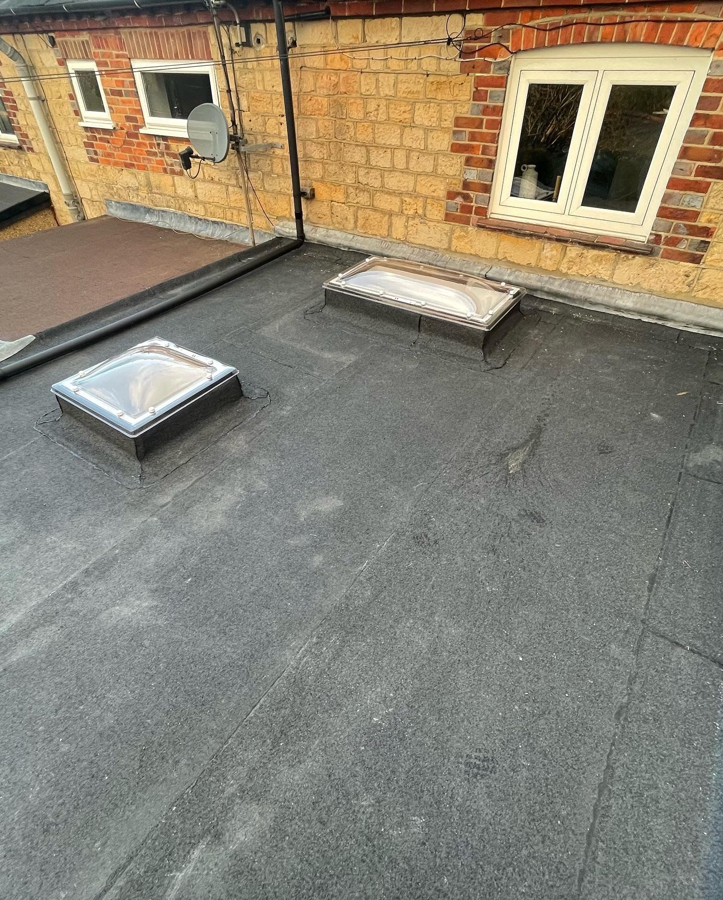 There are two skylights on the roof of a building.